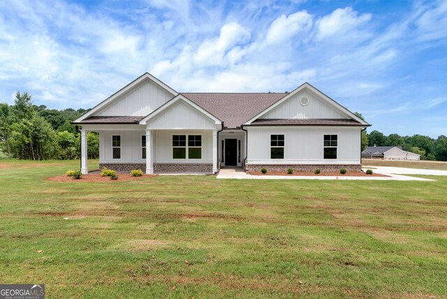797 Ode Peppers Rd, Winder, GA 30680 - modern farmhouse featuring a shingled roof, a front lawn, brick siding, and a porch