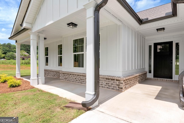 797 Ode Peppers Rd, Winder, GA 30680 - property entrance featuring board and batten siding, covered porch, and a shingled roof