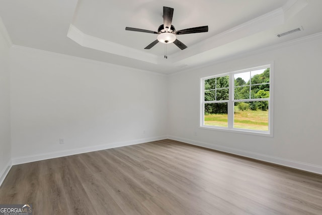 797 Ode Peppers Rd, Winder, GA 30680 - unfurnished room with a raised ceiling, wood finished floors, a ceiling fan, and ornamental molding