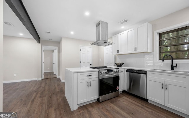 6402 Kensington Ct, Austell, GA 30106 - kitchen featuring appliances with stainless steel finishes, island range hood, a peninsula, white cabinetry, and dark wood finished floors