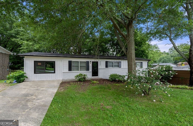 6402 Kensington Ct, Austell, GA 30106 - ranch-style home with concrete driveway, brick siding, a front lawn, and board and batten siding