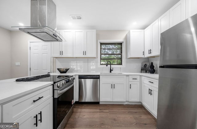 6402 Kensington Ct, Austell, GA 30106 - kitchen with stainless steel appliances, island range hood, white cabinets, light countertops, and recessed lighting