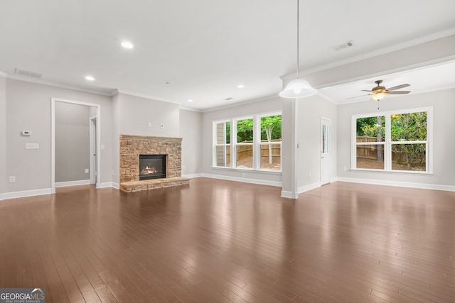 728 Lorimore Pass, Canton, GA 30115 - unfurnished living room featuring a ceiling fan, healthy amount of natural light, a stone fireplace, hardwood / wood-style floors, and ornamental molding