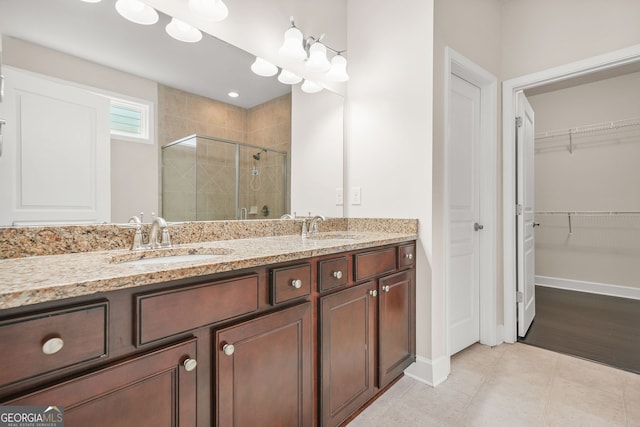 728 Lorimore Pass, Canton, GA 30115 - full bath with a shower stall, a walk in closet, and double vanity