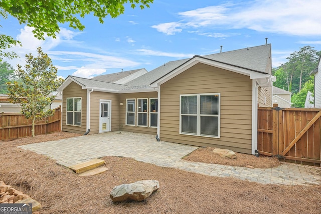 728 Lorimore Pass, Canton, GA 30115 - rear view of house featuring a patio, a shingled roof, and a gate