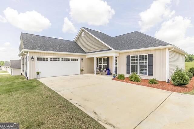 2303 Quail Ridge Ln, Perry, GA 31069 - view of front of home with a garage, a front lawn, concrete driveway, and roof with shingles