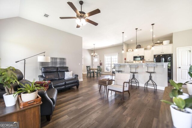 2303 Quail Ridge Ln, Perry, GA 31069 - living area with dark wood-style flooring, a ceiling fan, a chandelier, and vaulted ceiling