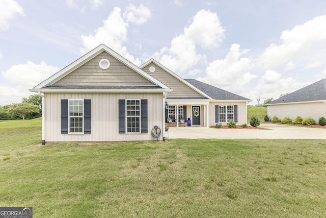 2303 Quail Ridge Ln, Perry, GA 31069 - back of property with board and batten siding, a lawn, and driveway