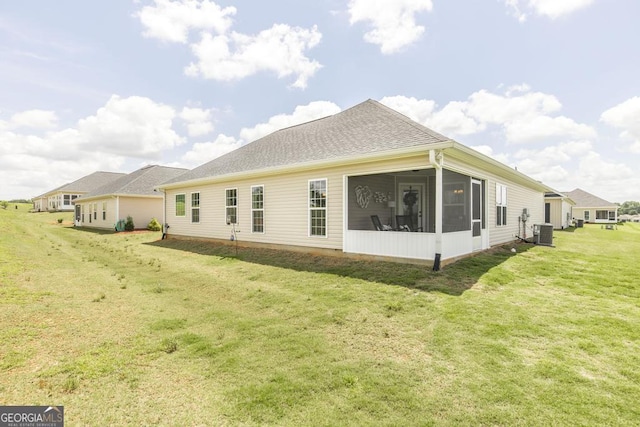 2303 Quail Ridge Ln, Perry, GA 31069 - rear view of house featuring a lawn and a sunroom
