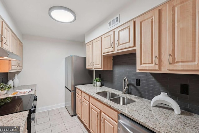 1166 Booth Rd SW Unit 301, Marietta, GA 30008 - kitchen with appliances with stainless steel finishes, light brown cabinetry, decorative backsplash, light tile patterned flooring, and light stone counters