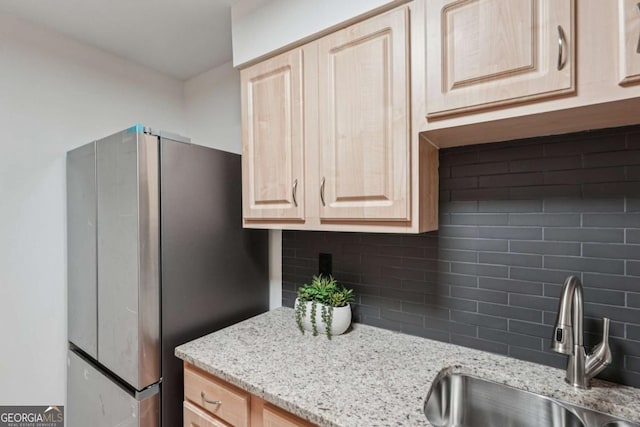 1166 Booth Rd SW Unit 301, Marietta, GA 30008 - kitchen featuring freestanding refrigerator, light brown cabinets, tasteful backsplash, and light stone countertops