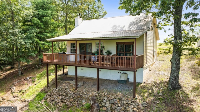 539 Dowel Cir, Ellijay, GA 30540 - back of property with a deck, a chimney, and a metal roof