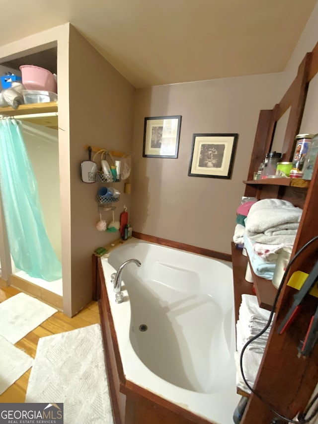 539 Dowel Cir, Ellijay, GA 30540 - full bath with a jetted tub, wood finished floors, and a shower with shower curtain