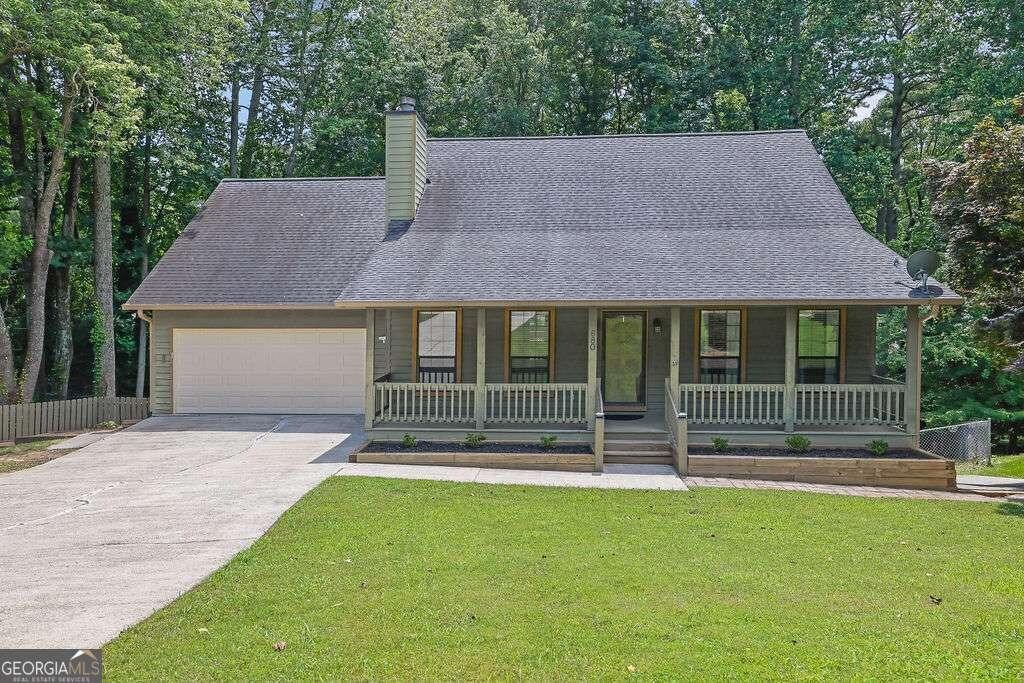 680 Spirit Falls Way, Johns Creek, GA 30022 - view of front of property featuring a garage, a porch, driveway, and a chimney