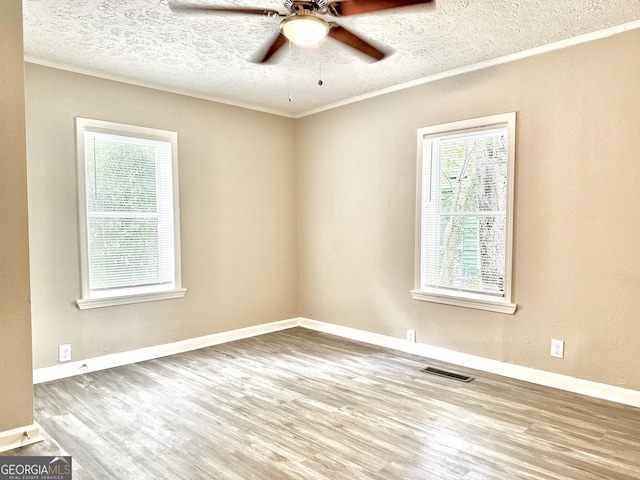 708 Degroat St, Lagrange, GA 30241 - spare room featuring wood finished floors, a ceiling fan, a textured ceiling, and ornamental molding