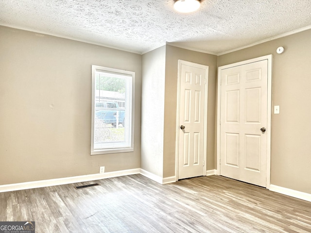 708 Degroat St, Lagrange, GA 30241 - unfurnished bedroom featuring wood finished floors and a textured ceiling