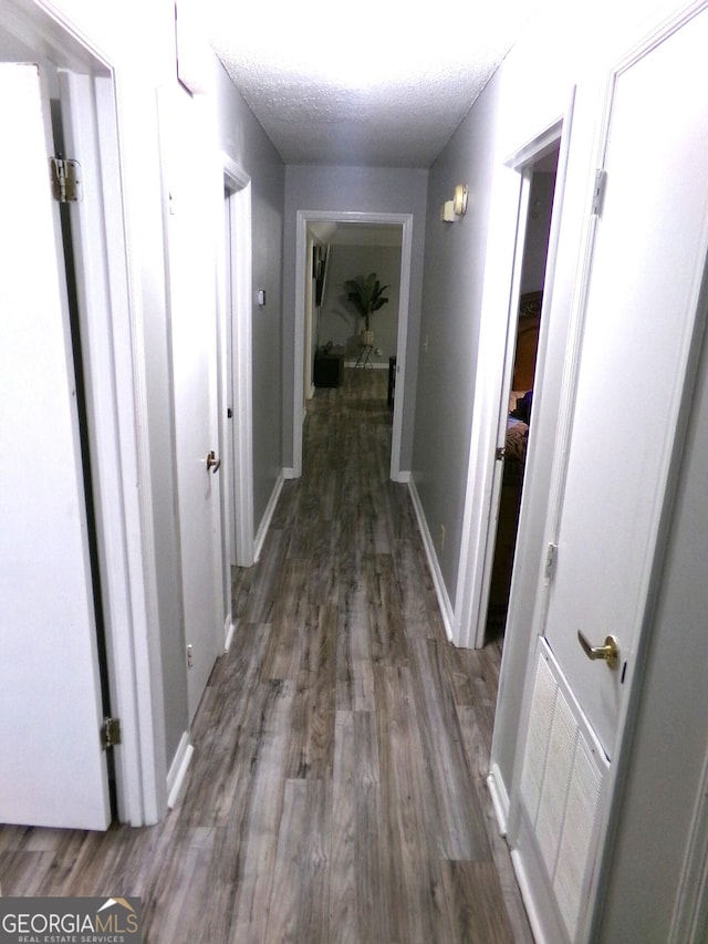871 Chisholm Trl, Macon, GA 31220 - hallway with wood finished floors and a textured ceiling