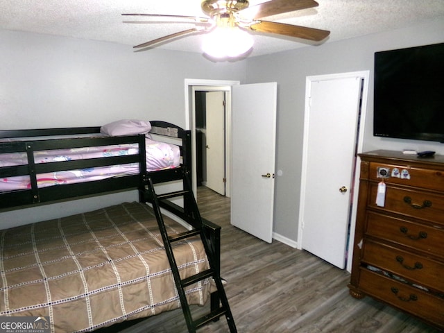 871 Chisholm Trl, Macon, GA 31220 - bedroom featuring wood finished floors, a textured ceiling, and a ceiling fan