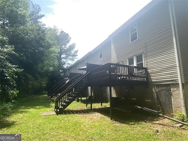 8955 Stonebridge Blvd, Douglasville, GA 30134 - back of house with stairs, a deck, and a lawn