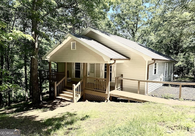 83 Austin Ct, Dahlonega, GA 30533 - view of front of home with a metal roof, covered porch, and view of scattered trees