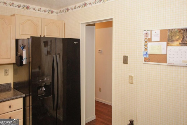 125 Pebble Beach Ct, Atlanta, GA 30349 - kitchen with black refrigerator with ice dispenser, light brown cabinets, dark countertops, dark wood-type flooring, and wallpapered walls