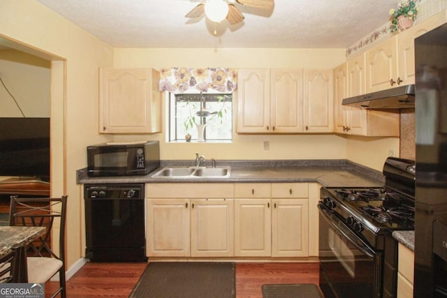 125 Pebble Beach Ct, Atlanta, GA 30349 - kitchen featuring black appliances, under cabinet range hood, ceiling fan, dark wood-style flooring, and dark countertops