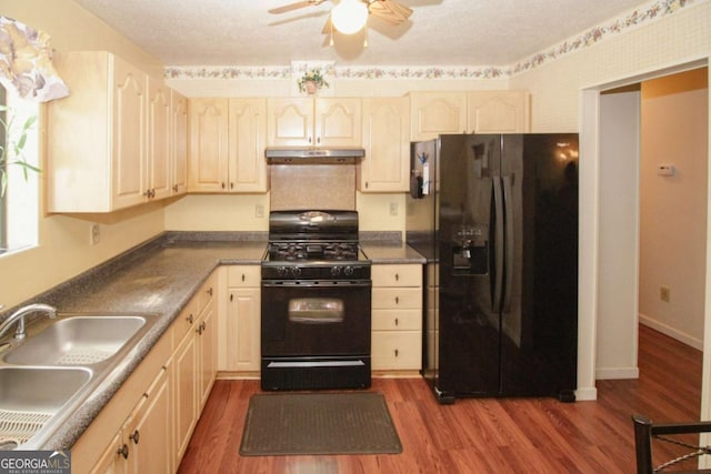 125 Pebble Beach Ct, Atlanta, GA 30349 - kitchen featuring black appliances, under cabinet range hood, ceiling fan, dark wood-style floors, and dark countertops