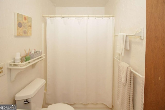125 Pebble Beach Ct, Atlanta, GA 30349 - bathroom featuring toilet and a shower with shower curtain
