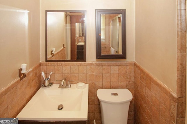 125 Pebble Beach Ct, Atlanta, GA 30349 - bathroom featuring a wainscoted wall, tile walls, and vanity