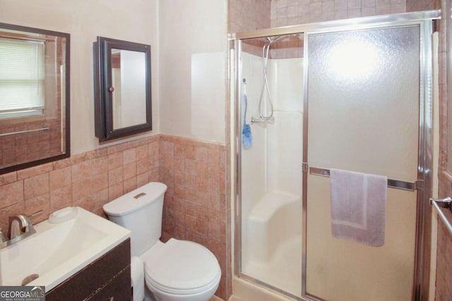 125 Pebble Beach Ct, Atlanta, GA 30349 - full bathroom featuring tile walls, vanity, a shower stall, and a wainscoted wall