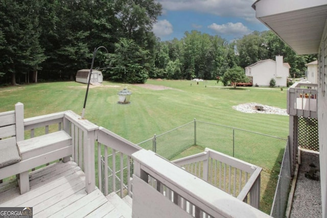 125 Pebble Beach Ct, Atlanta, GA 30349 - view of green lawn with a storage shed and a deck