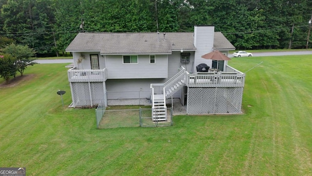 125 Pebble Beach Ct, Atlanta, GA 30349 - rear view of house featuring stairway, a lawn, a wooden deck, and a chimney