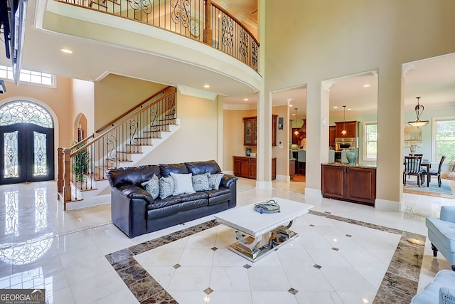 805 Cog Hl, Mcdonough, GA 30253 - living room featuring a towering ceiling, stairway, light tile patterned floors, arched walkways, and recessed lighting