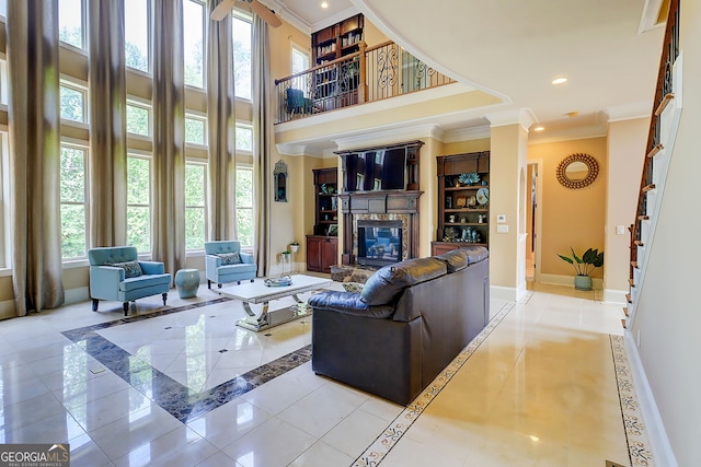 805 Cog Hl, Mcdonough, GA 30253 - tiled living area with inlaid floor details, ornamental molding, a glass covered fireplace, a high ceiling, and recessed lighting