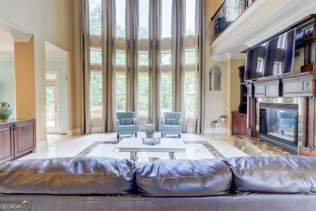 805 Cog Hl, Mcdonough, GA 30253 - living area featuring a high ceiling, inlaid floor details, healthy amount of natural light, a high end fireplace, and marble tiled flooring