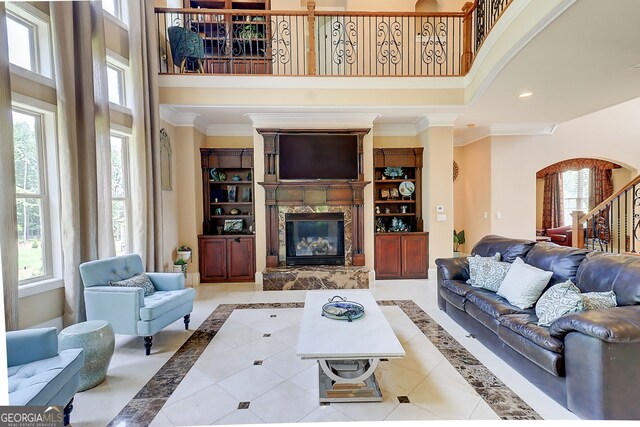 805 Cog Hl, Mcdonough, GA 30253 - tiled living area with a high ceiling, a premium fireplace, ornamental molding, inlaid floor details, and recessed lighting