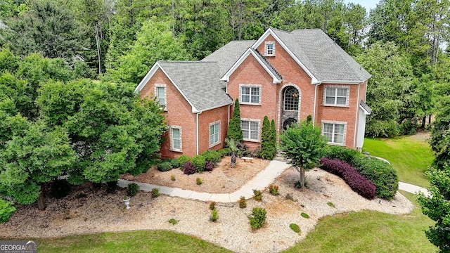 805 Cog Hl, Mcdonough, GA 30253 - view of front of home with brick siding, a front lawn, roof with shingles, and a wooded view