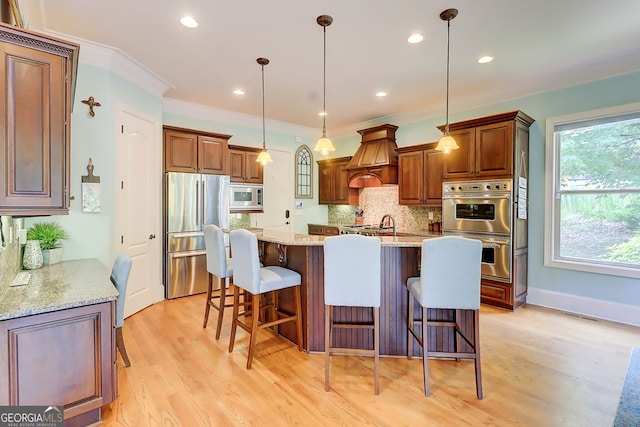 805 Cog Hl, Mcdonough, GA 30253 - kitchen with stainless steel appliances, tasteful backsplash, custom exhaust hood, crown molding, and light wood finished floors