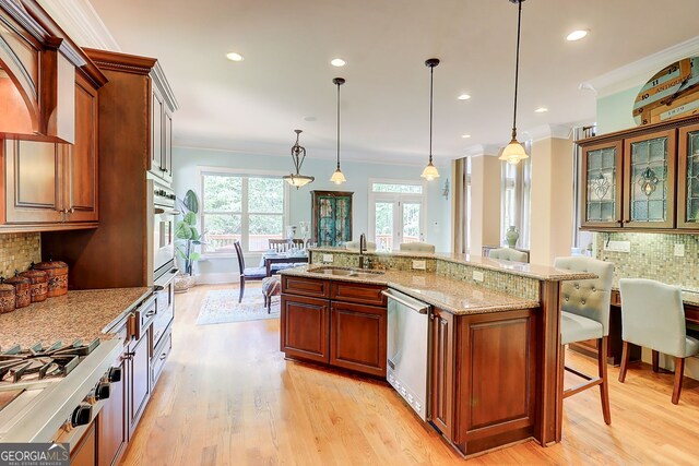 805 Cog Hl, Mcdonough, GA 30253 - kitchen featuring stainless steel appliances, backsplash, a breakfast bar, crown molding, and light stone counters
