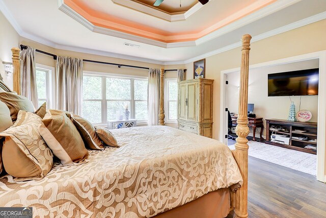 805 Cog Hl, Mcdonough, GA 30253 - bedroom featuring a raised ceiling, crown molding, wood finished floors, and ceiling fan