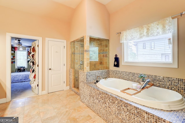 805 Cog Hl, Mcdonough, GA 30253 - bathroom featuring a stall shower, plenty of natural light, a bath, and a towering ceiling