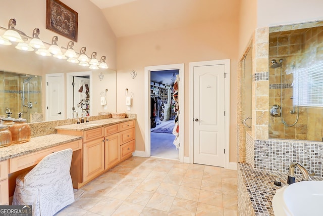 805 Cog Hl, Mcdonough, GA 30253 - bathroom featuring a stall shower, vanity, a tub to relax in, a walk in closet, and high vaulted ceiling