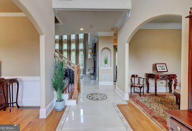 805 Cog Hl, Mcdonough, GA 30253 - foyer featuring crown molding, arched walkways, stairway, and tile patterned floors
