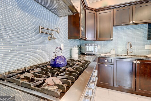 805 Cog Hl, Mcdonough, GA 30253 - kitchen featuring stone countertops, decorative backsplash, dark brown cabinets, and light tile patterned floors