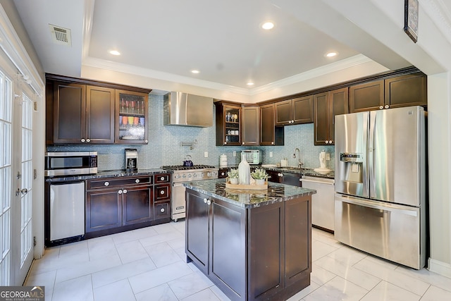 805 Cog Hl, Mcdonough, GA 30253 - kitchen featuring stainless steel appliances, wall chimney exhaust hood, dark stone countertops, glass insert cabinets, and crown molding