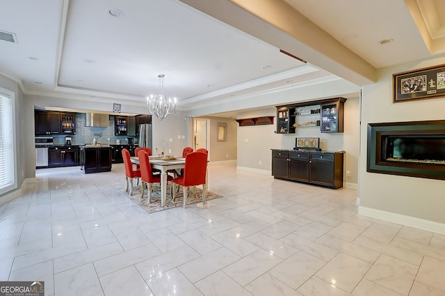 805 Cog Hl, Mcdonough, GA 30253 - dining space with a raised ceiling, a chandelier, light marble finish flooring, and ornamental molding