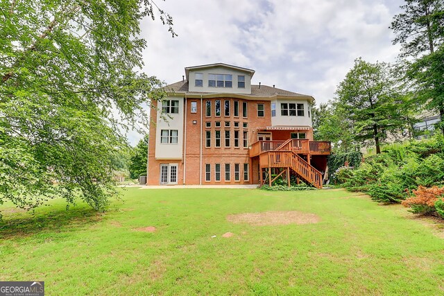 805 Cog Hl, Mcdonough, GA 30253 - rear view of property featuring stairway, a lawn, a deck, and brick siding