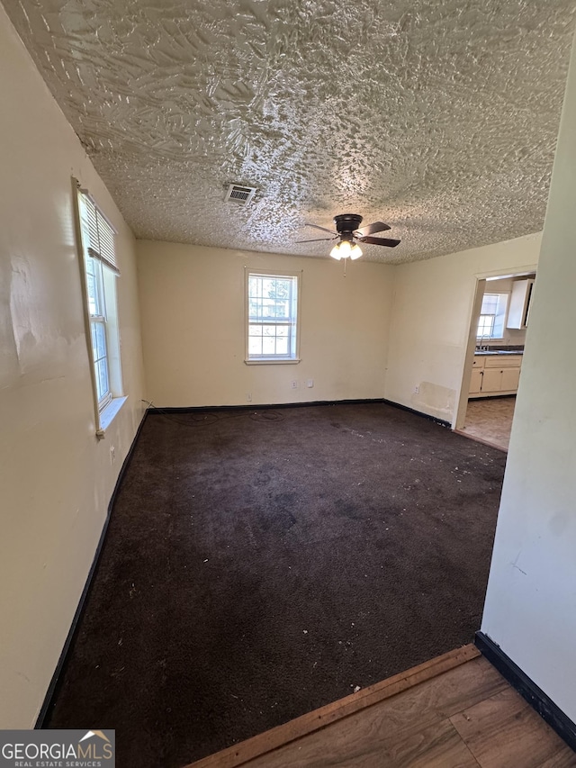 1004 Mapp St, Madison, GA 30650 - spare room with ceiling fan and a textured ceiling