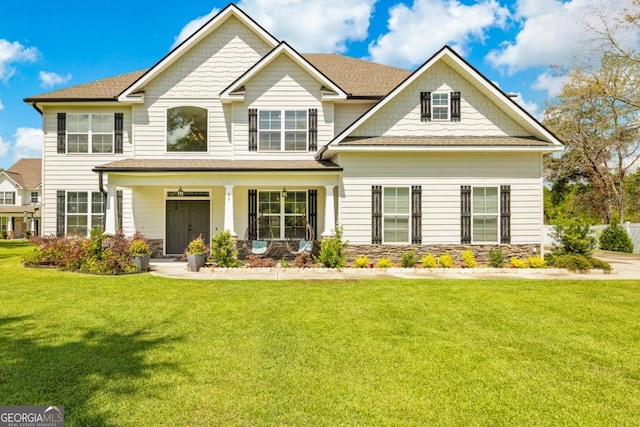89 Crestview Dr, Guyton, GA 31312 - craftsman-style house featuring a front yard, stone siding, a shingled roof, and covered porch