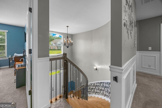 89 Crestview Dr, Guyton, GA 31312 - staircase with a wainscoted wall, carpet floors, and a chandelier